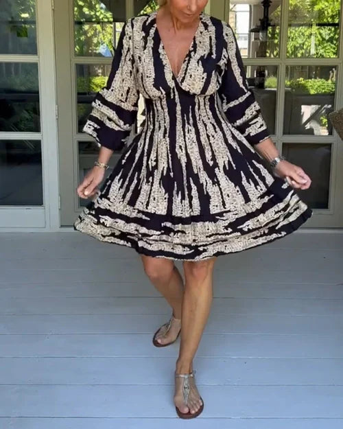 Flowy women's summer dress with a V-neck, 3/4 sleeves & an A-line silhouette. Perfect for casual everyday comfort.