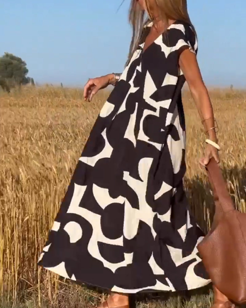 Elegant V-Neck Maxi Dress with vibrant print, ideal for spring fashion and vacation outfits.