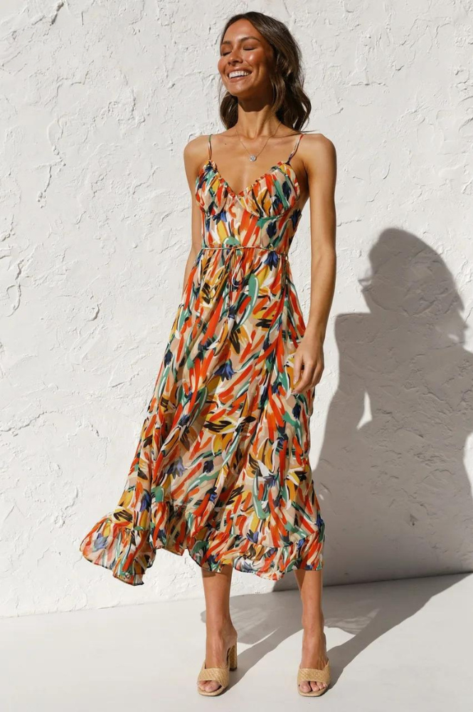 Women's vibrant floral print sleeveless summer dress with a flowy design, perfect for beachwear.