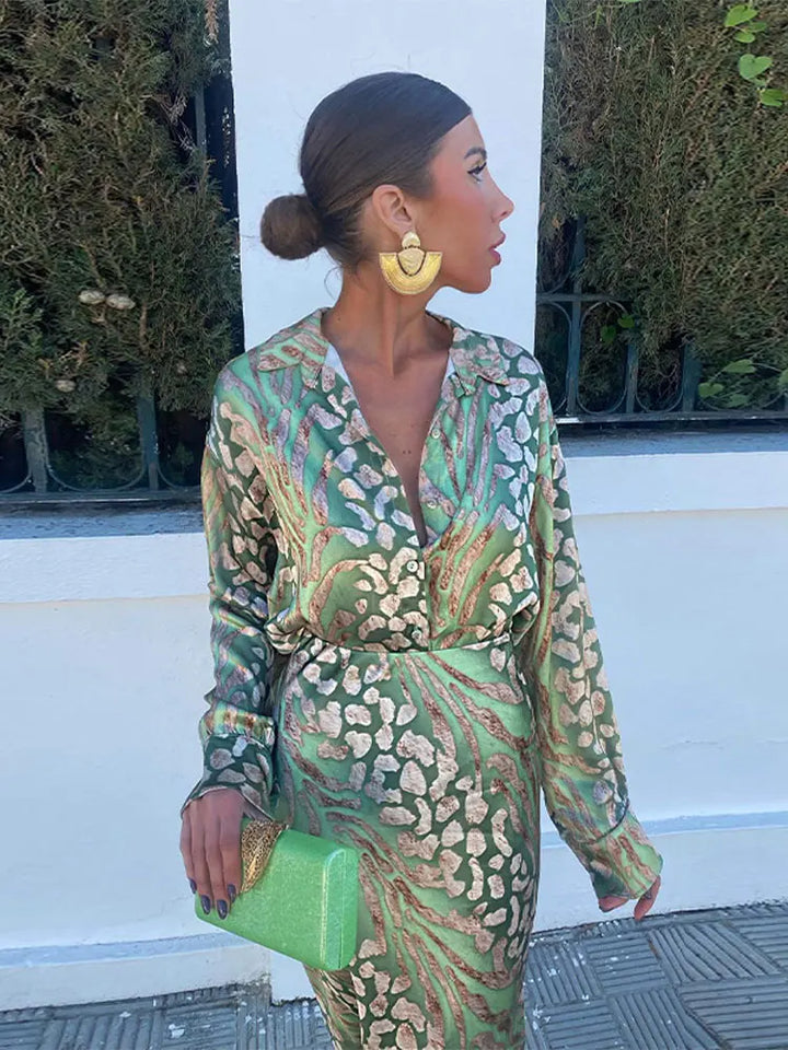 Luxurious patterned polyester women's summer set, including a vibrant short-sleeved blouse and matching flowing skirt.