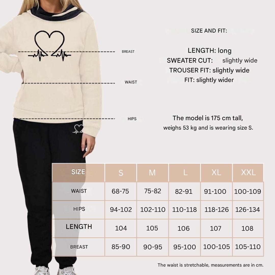 Full length view of a woman wearing a black WARMFLEX cozy tracksuit. Ideal for comfort & daily style.