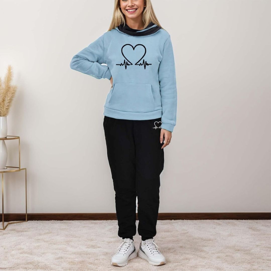 Model in grey WARMFLEX women's tracksuit. Cozy two-piece hoodie & pants for relaxing or active wear.