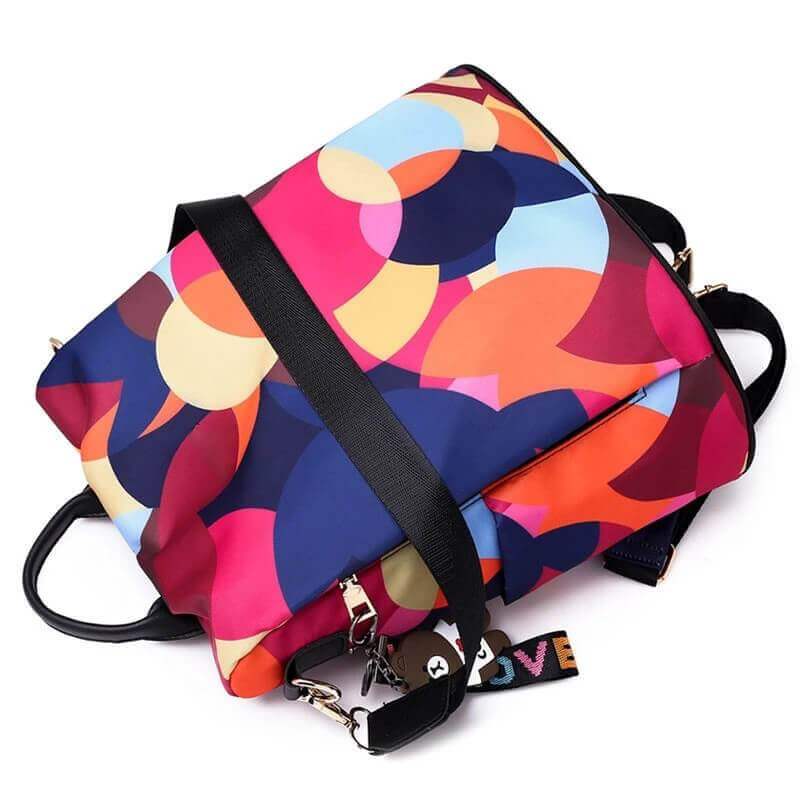 Group of SafeHold water-resistant anti-theft women's backpacks in various colors, multi-compartment
