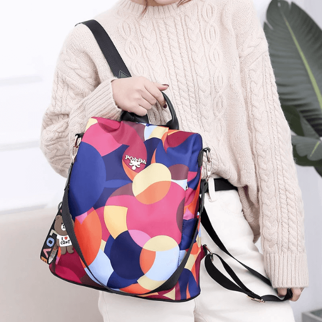 Woman wearing SafeHold anti-theft everyday backpack, water-resistant nylon material