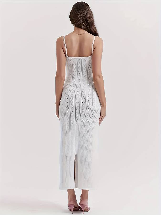 Sleeveless white boho dress featuring an intricate lace-up front and delicate crochet patterns. Summer essential.