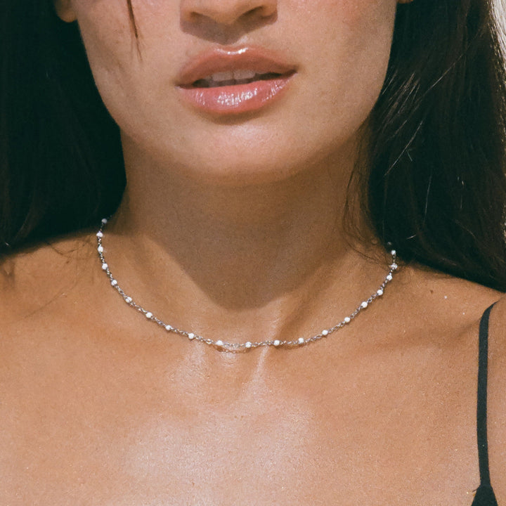 Chic white enamel bead choker necklace for women. Fashion-forward accessory.