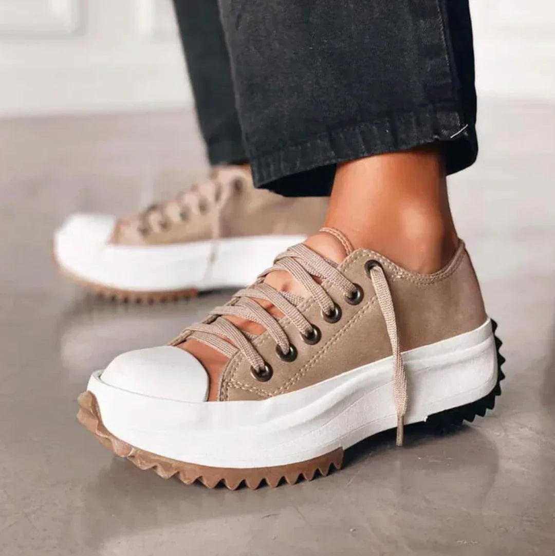 Women's white platform sneakers with lace-up design, perfect for elevating casual everyday style and comfort.
