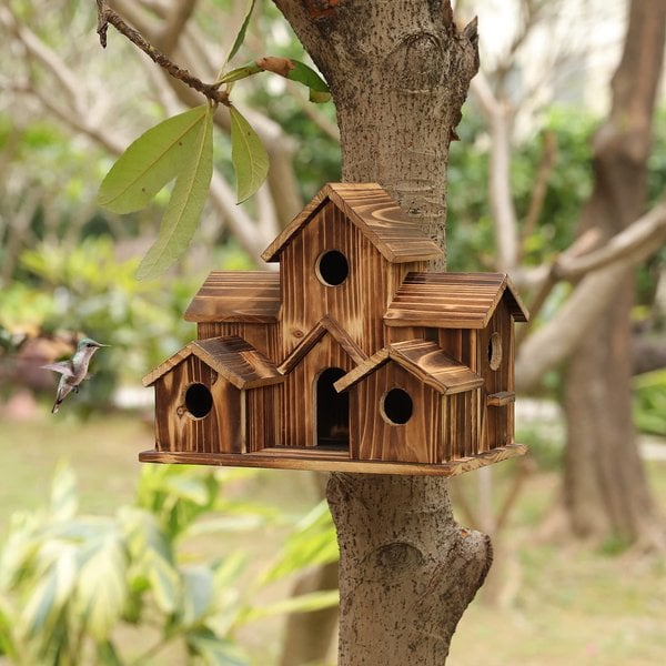 Rustic wooden birdhouse, Nestora, adding charm to any garden or outdoor wildlife habitat