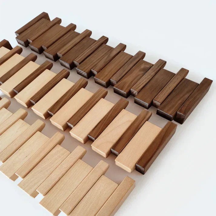 Space-saving wooden piano keys coat rack on a white wall, ideal for modern home decor