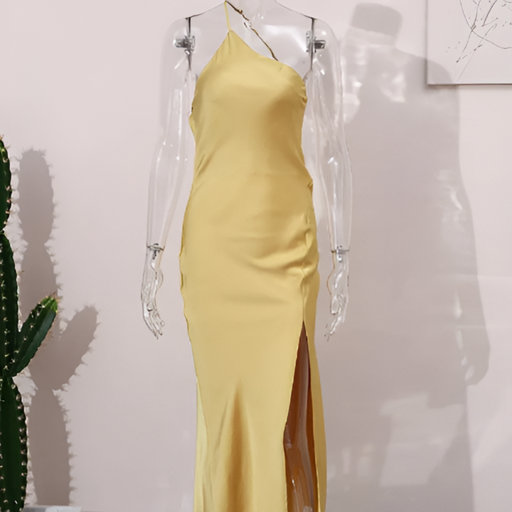 Stylish women's yellow summer dress featuring an open back and flowy design, great for casual wear or evening events.