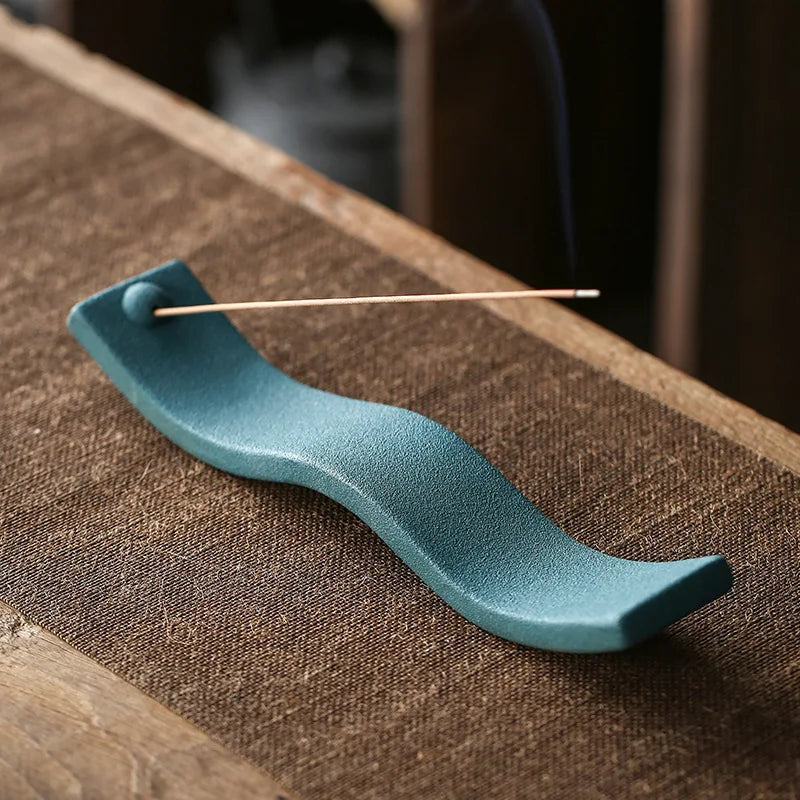 Elegant Zen Wave ceramic incense burner, enhancing home decor. Creates relaxing ambiance for meditation.