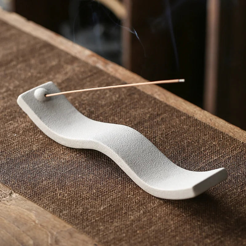 Handcrafted ceramic incense holder with wave design for home decor. Perfect for zen, relaxation, fragrance.